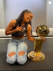 Dr. Chelsea Jackson Roberts with NBA Trophy Larry, Peloton Instructor Superlatives winner for Most Likely to send an encouraging text at 2am