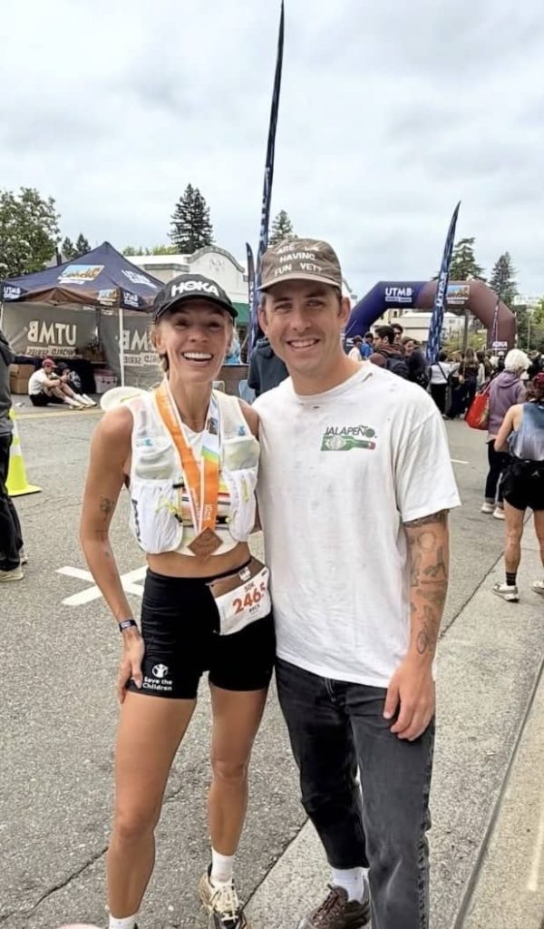 Becs Gentry Canyons 50k - with medal and standing with Austin