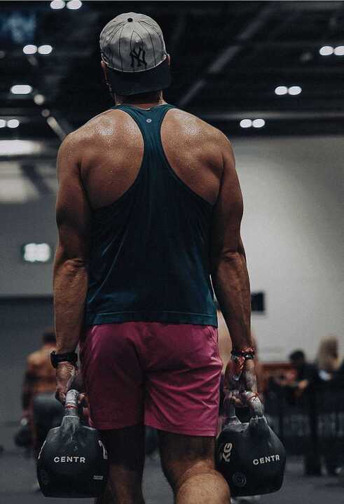 Listening to your body in competition, Man carrying kettlebells 