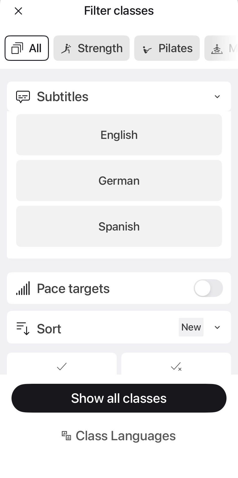 Peloton class language filter screen showing toggle controls for English, German, and Spanish instruction with subtitle options on a mobile device.