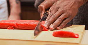 Mr. Moto Adrian Williams cuts sushi