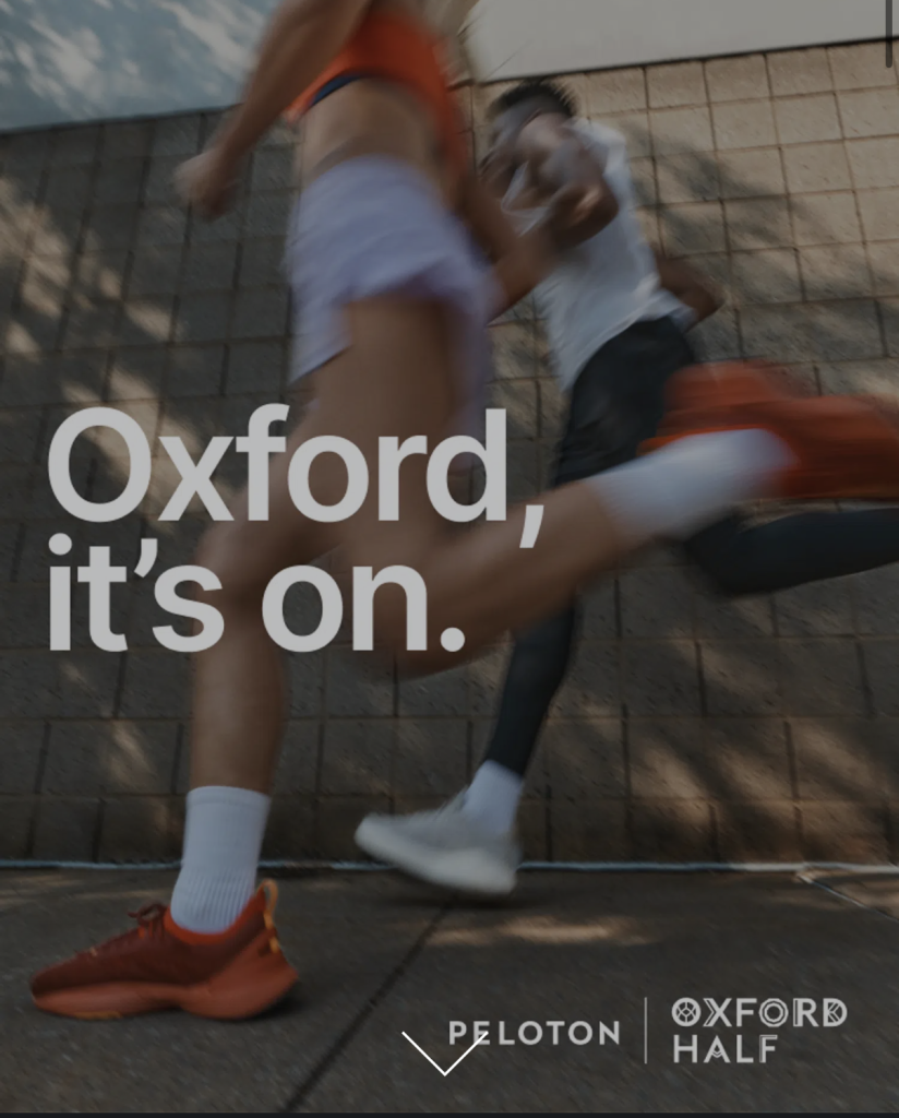Oxford Half Marathon campaign image showing two runners in motion with Peloton and Oxford Half branding