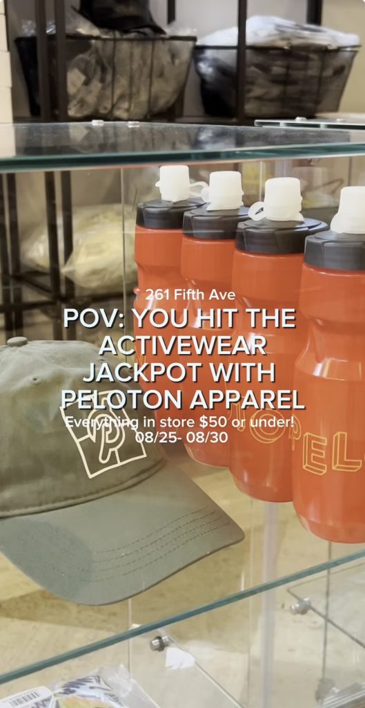 Peloton Apparel sample sale display of water bottles, hats, and accessories