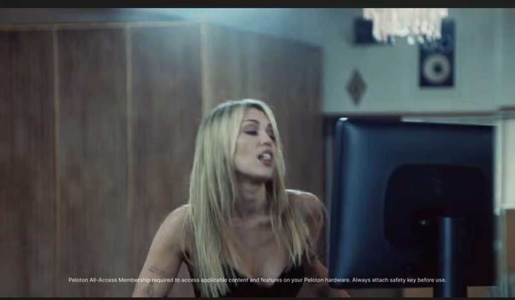 Miley Cyrus Peloton ad still of Miley singing on the Peloton Tread