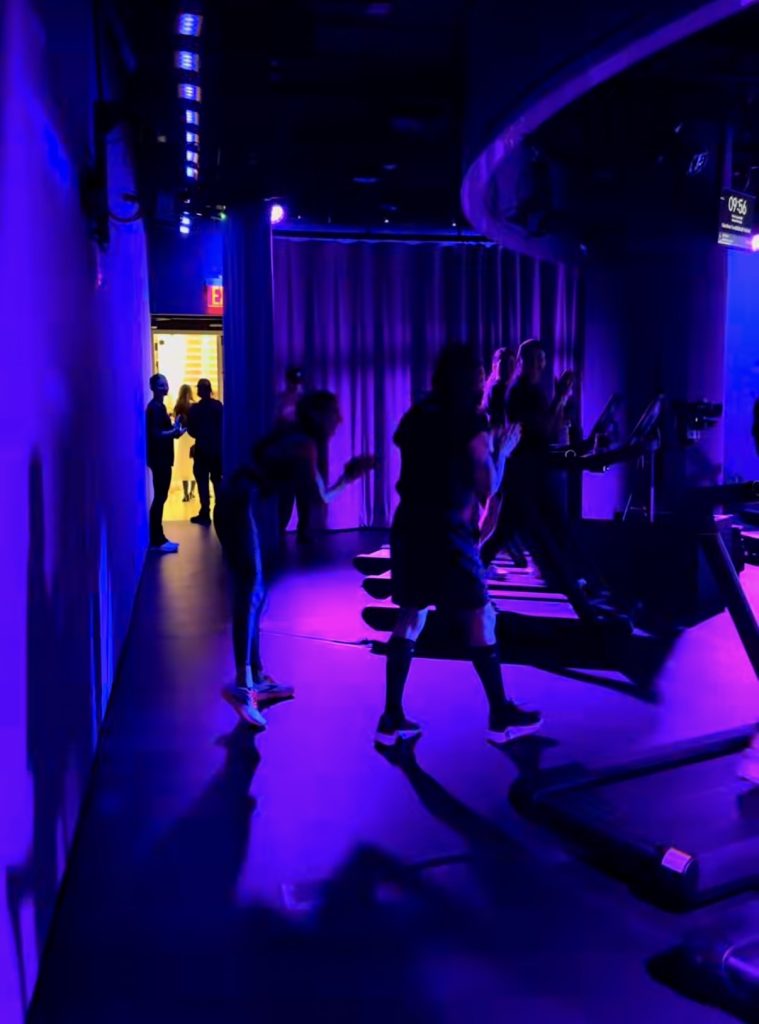 Juanes Walk members clapping on Treads in the Peloton studio