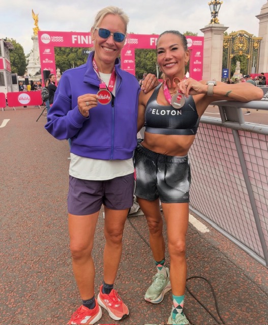 Peloton instructor races: Susie Chan and a fellow runner hold their Vitality London 10K medals