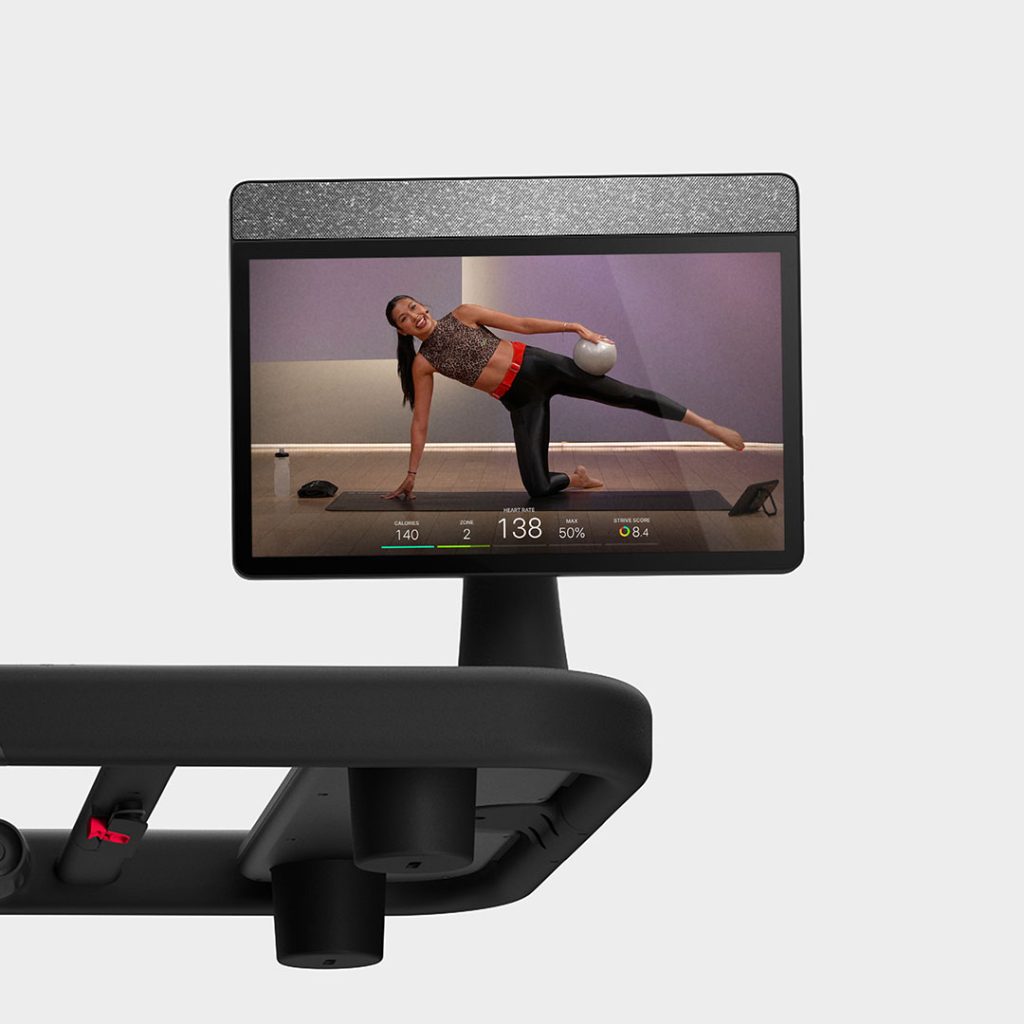 Peloton Tread Flex swivel screen showing a floor-based mat class with live heart rate and calorie metrics