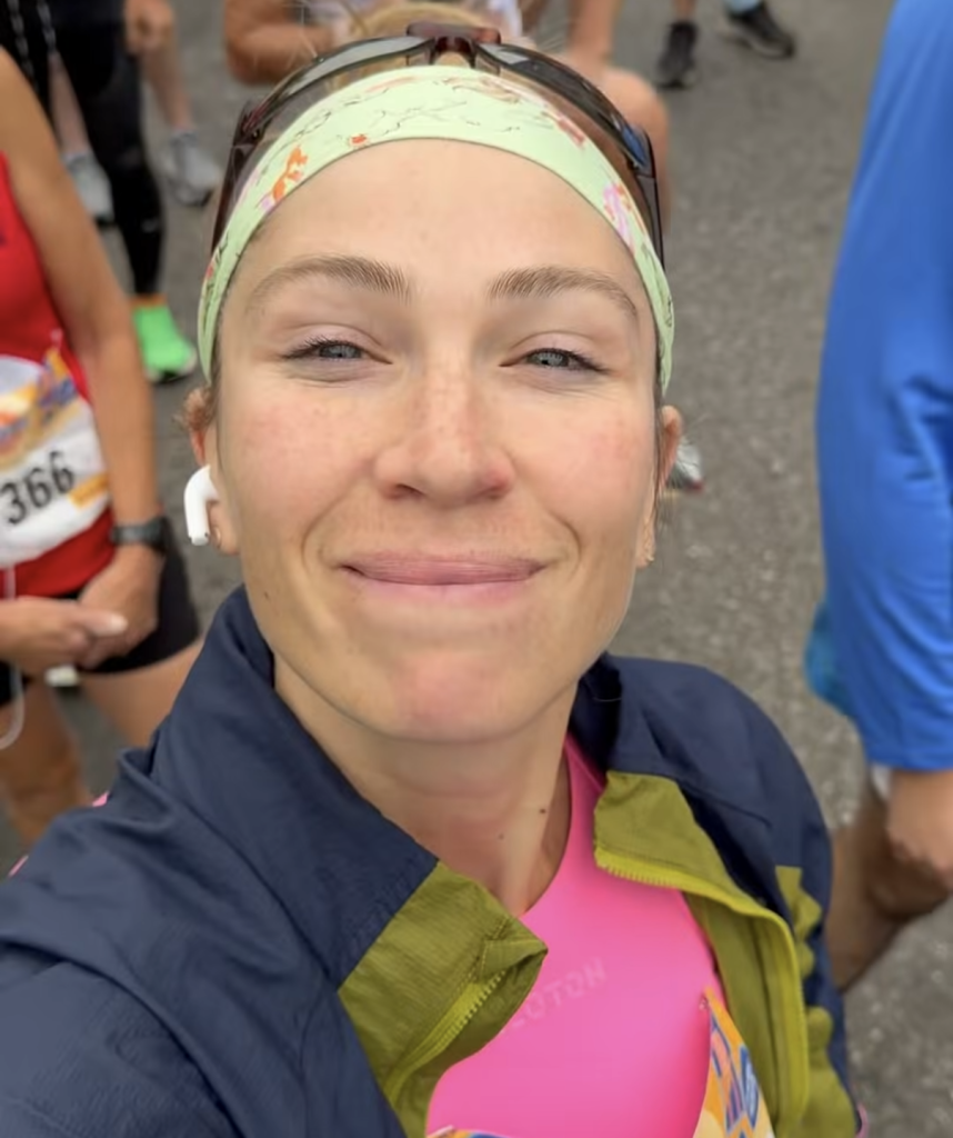 Peloton instructors race weekend Selena Samuela with her Staten Island Half medal in the rain