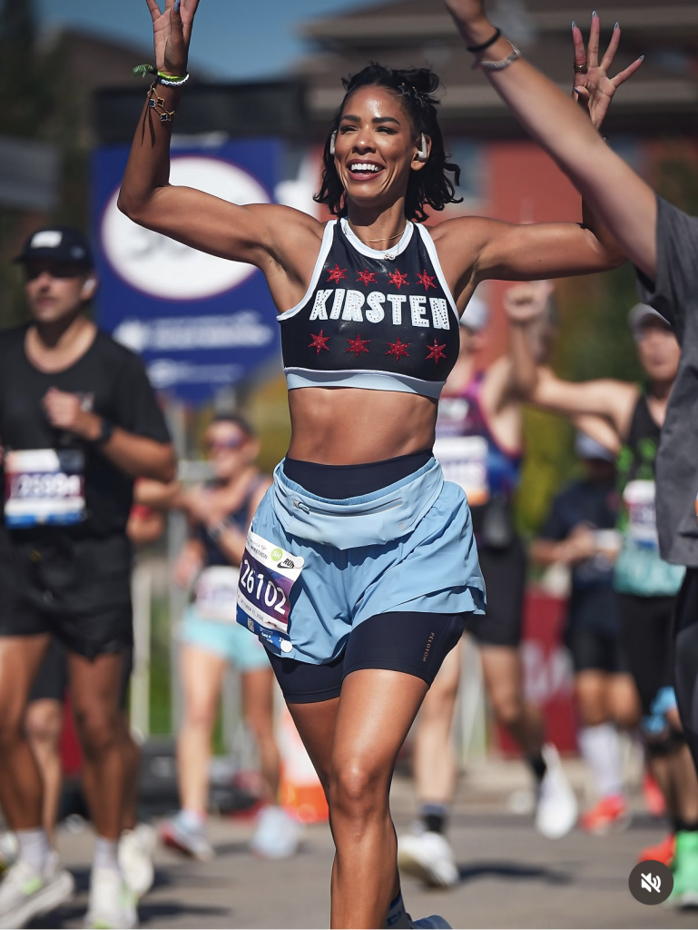 Kirsten Ferguson running the 2026 Bank of America Chicago Marathon in a Chicago star crop top with her name on it