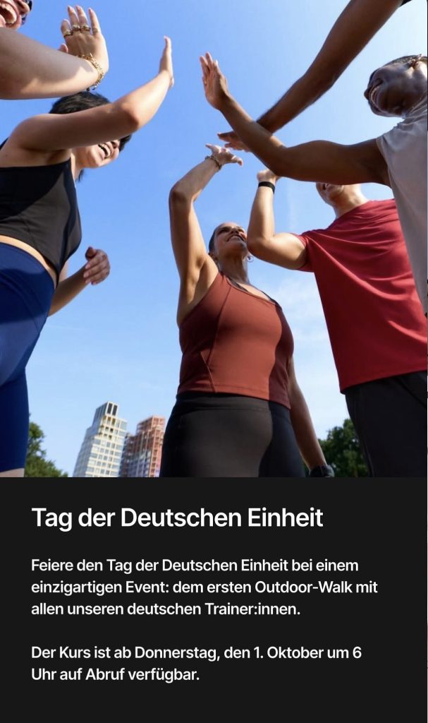 Peloton German Unity Day walk group high-fiving outdoors under a blue sky
