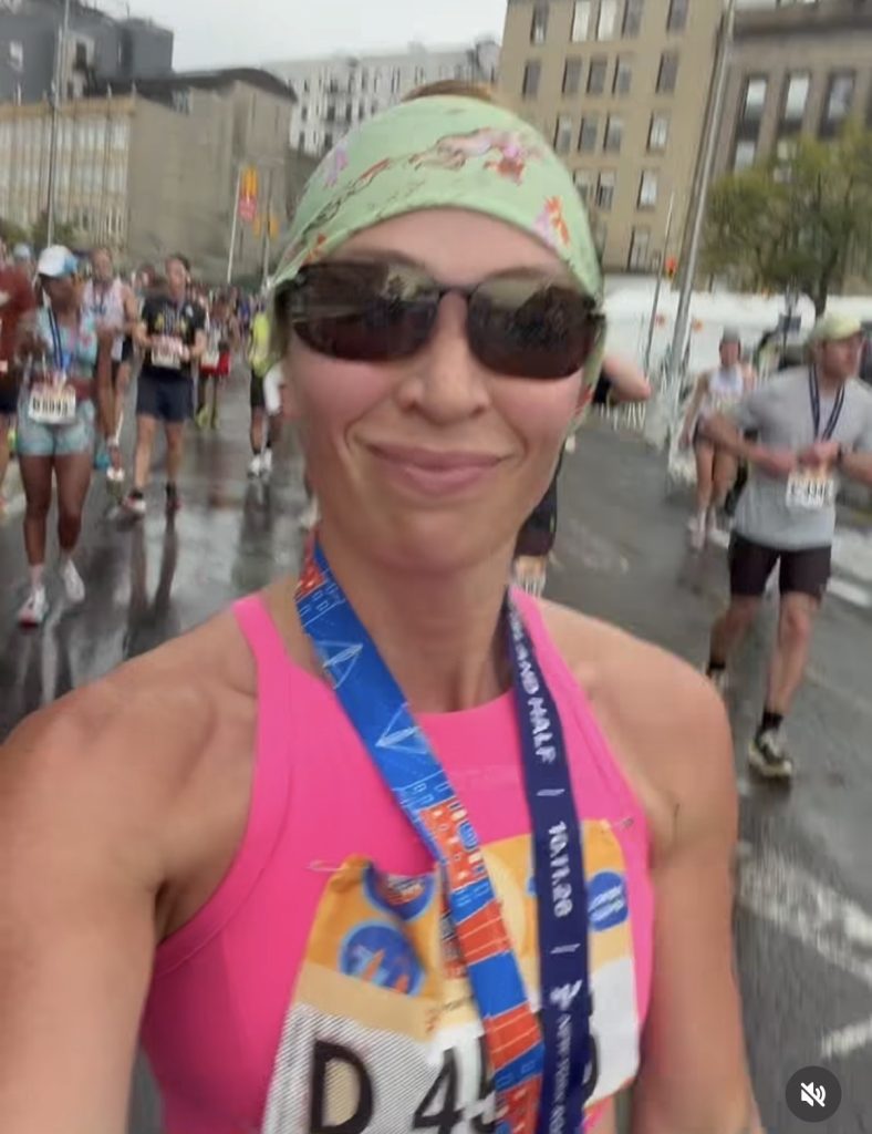 Peloton instructors race weekend Selena Samuela with her Staten Island Half medal in the rain