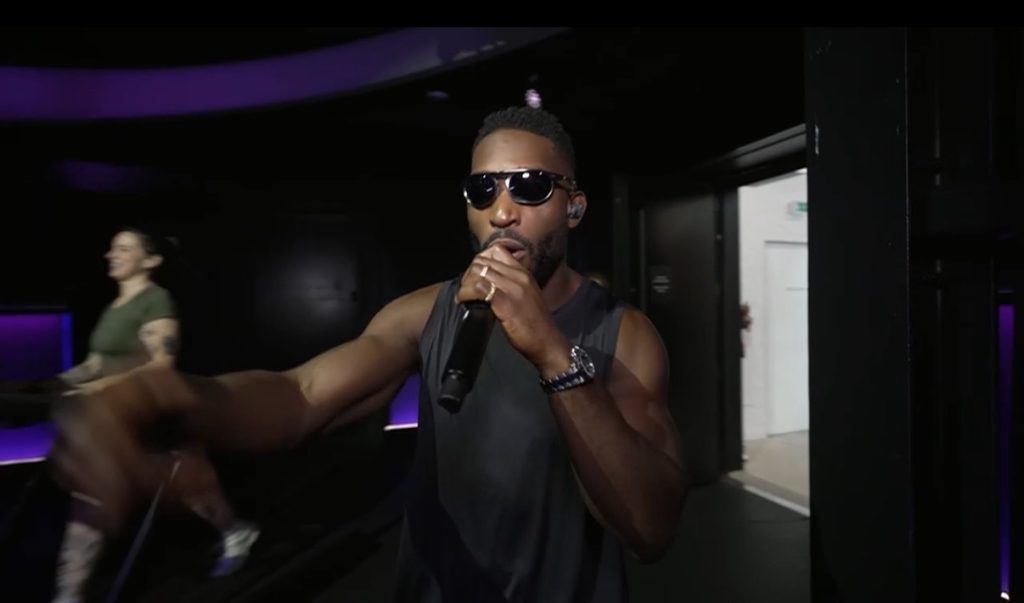 Tinie Tempah Peloton Dance Music Run with members on Treads under purple studio lights