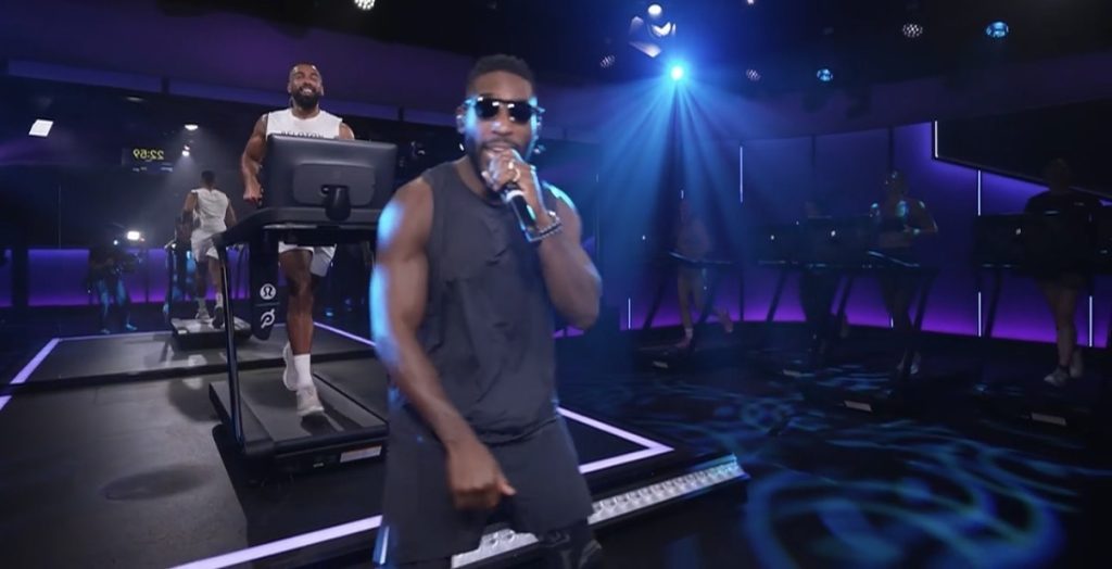Tinie Tempah Peloton class as Jermaine Johnson smiles at Tinie mid-run
