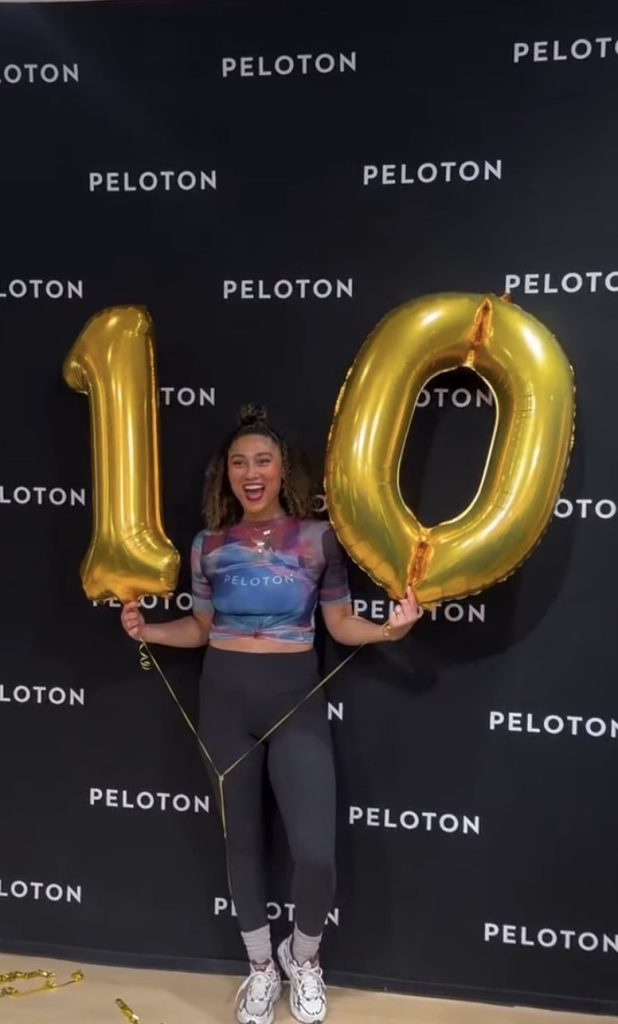 Ally Love Peloversary celebration with gold 10 balloons at Peloton Studios