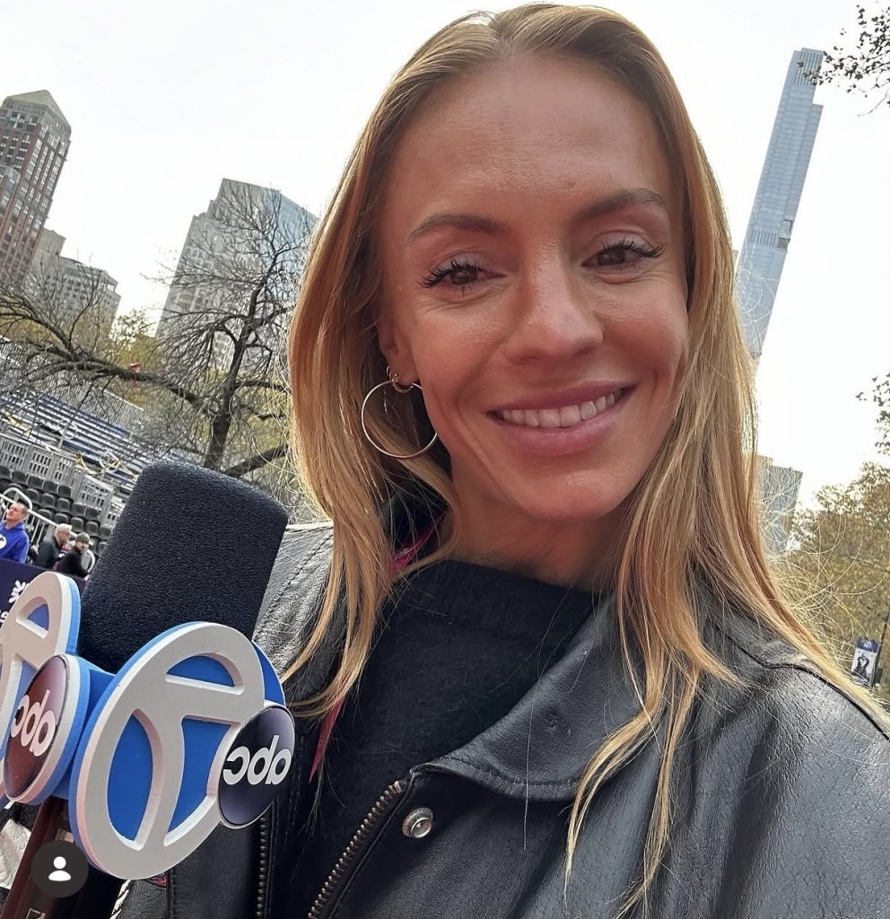 Becs Gentry NYC Marathon reporter Becs Gentry with an ABC7 microphone near the Central Park finish area in 2023